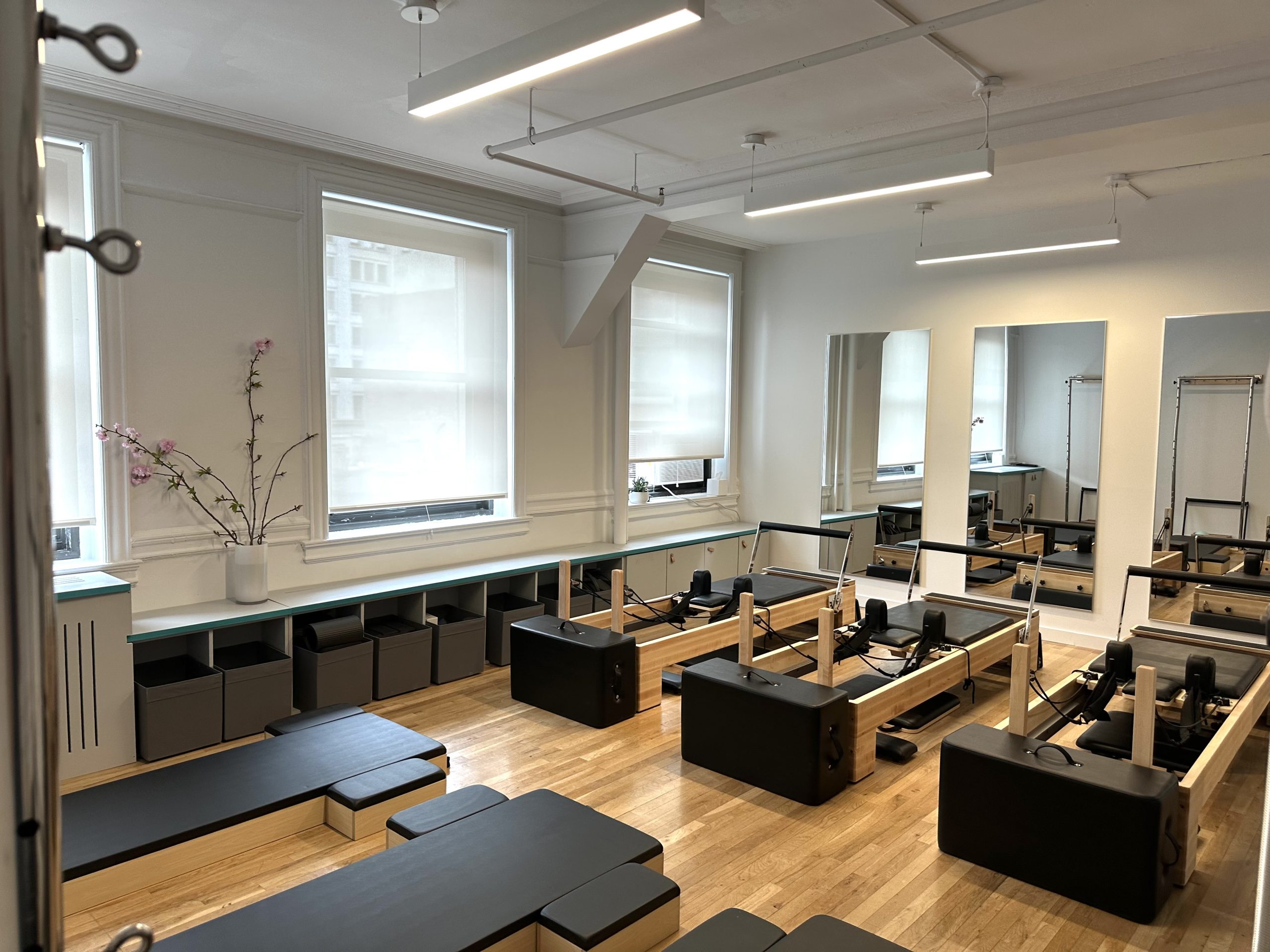 The Pilates floor at 41 Union Square West, with reformers, wall towers and mirrors